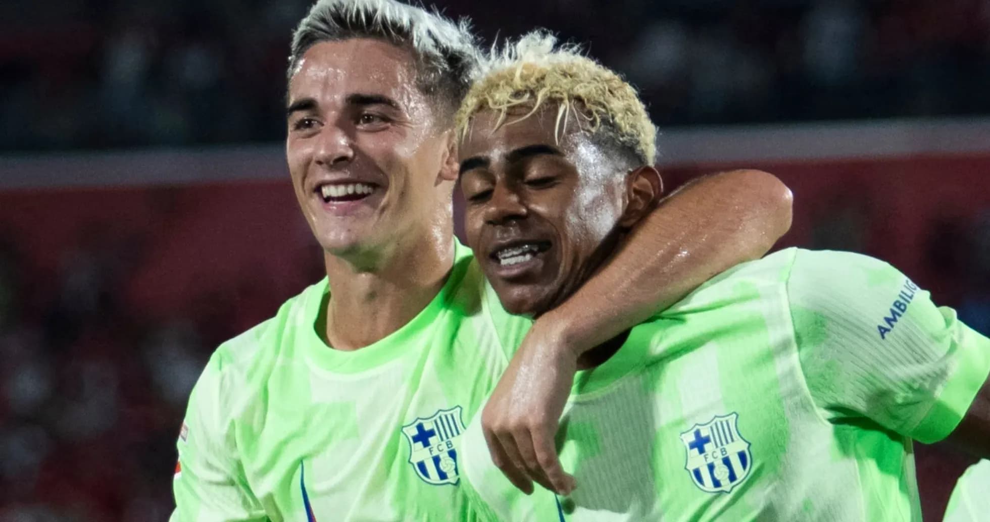 Two players celebrating a goal on the field Two players celebrating a goal on the field