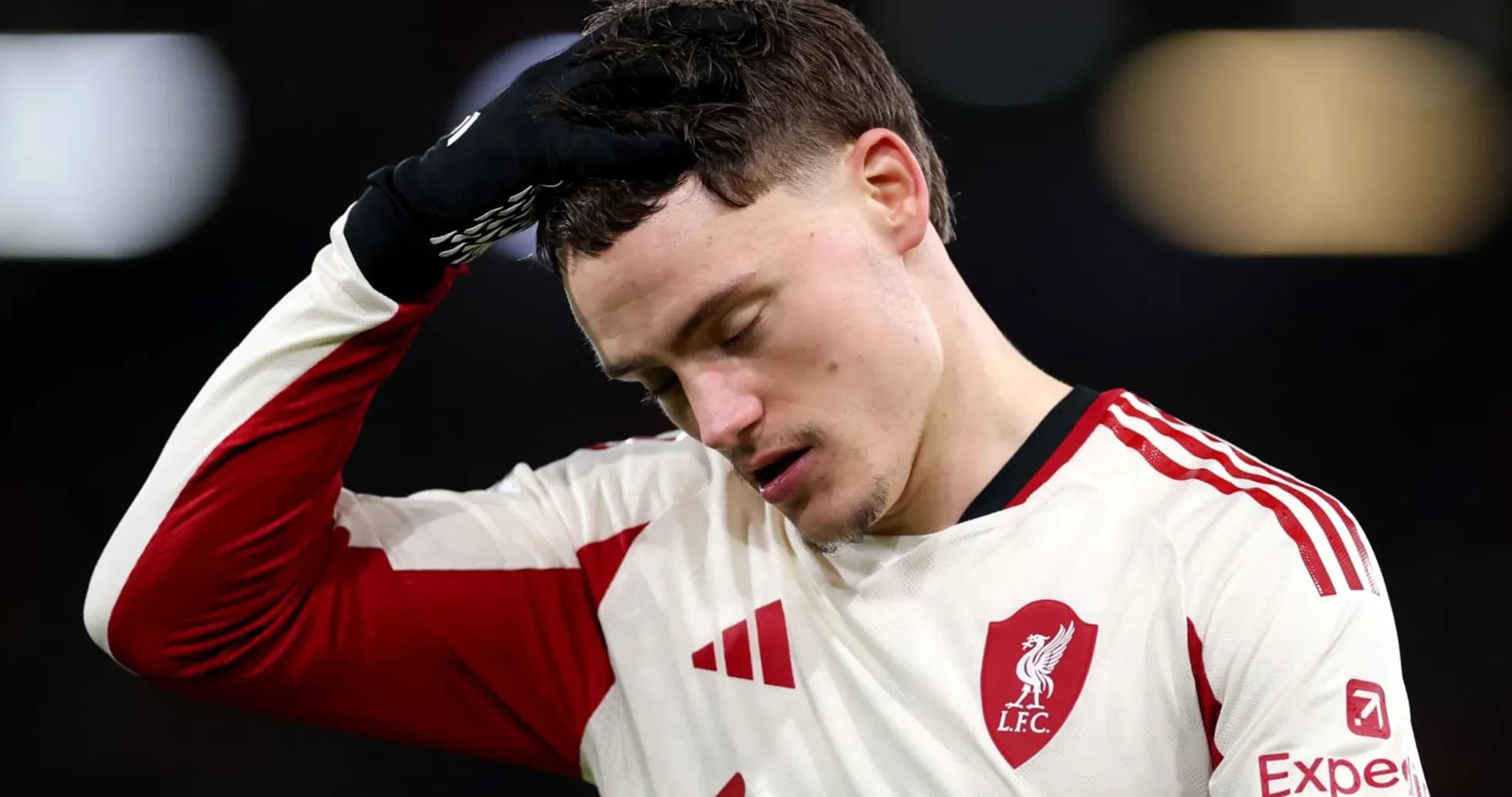 Player in Liverpool jersey looking down after match Player in Liverpool jersey looking down after match