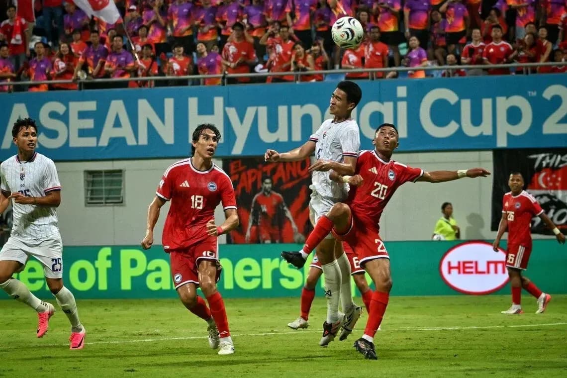 Players competing for the ball during ASEAN Cup match Players competing for the ball during ASEAN Cup match