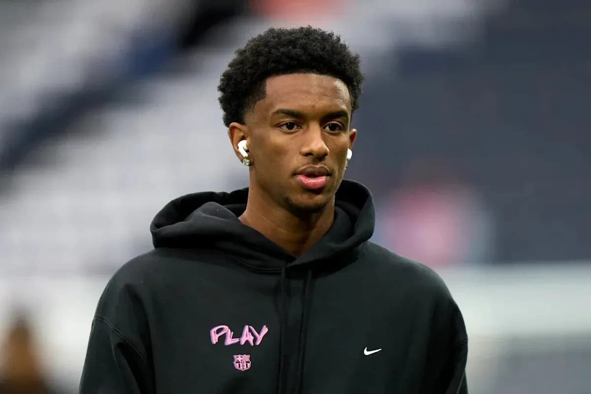 Athlete wearing earbuds and hoodie before game Athlete wearing earbuds and hoodie before game