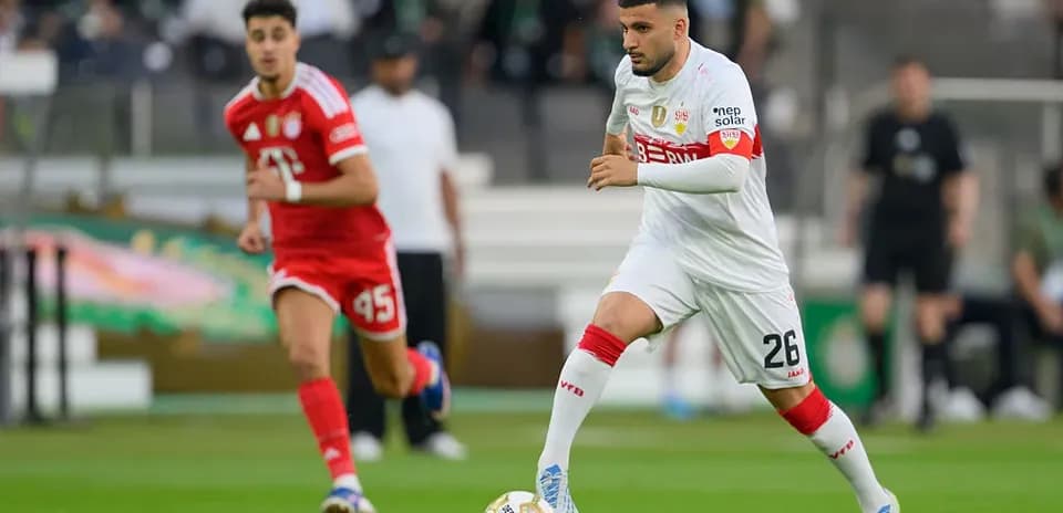 Player dribbling the ball during a soccer match Player dribbling the ball during a soccer match