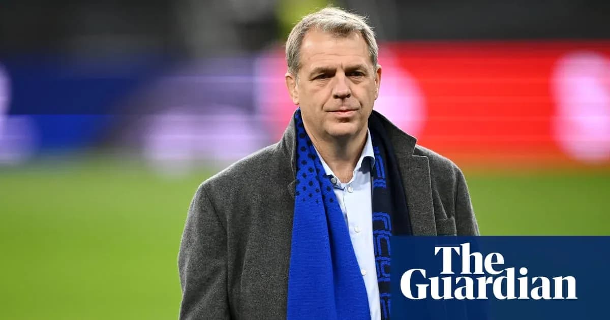 Man in coat with scarf at sports venue Man in coat with scarf at sports venue
