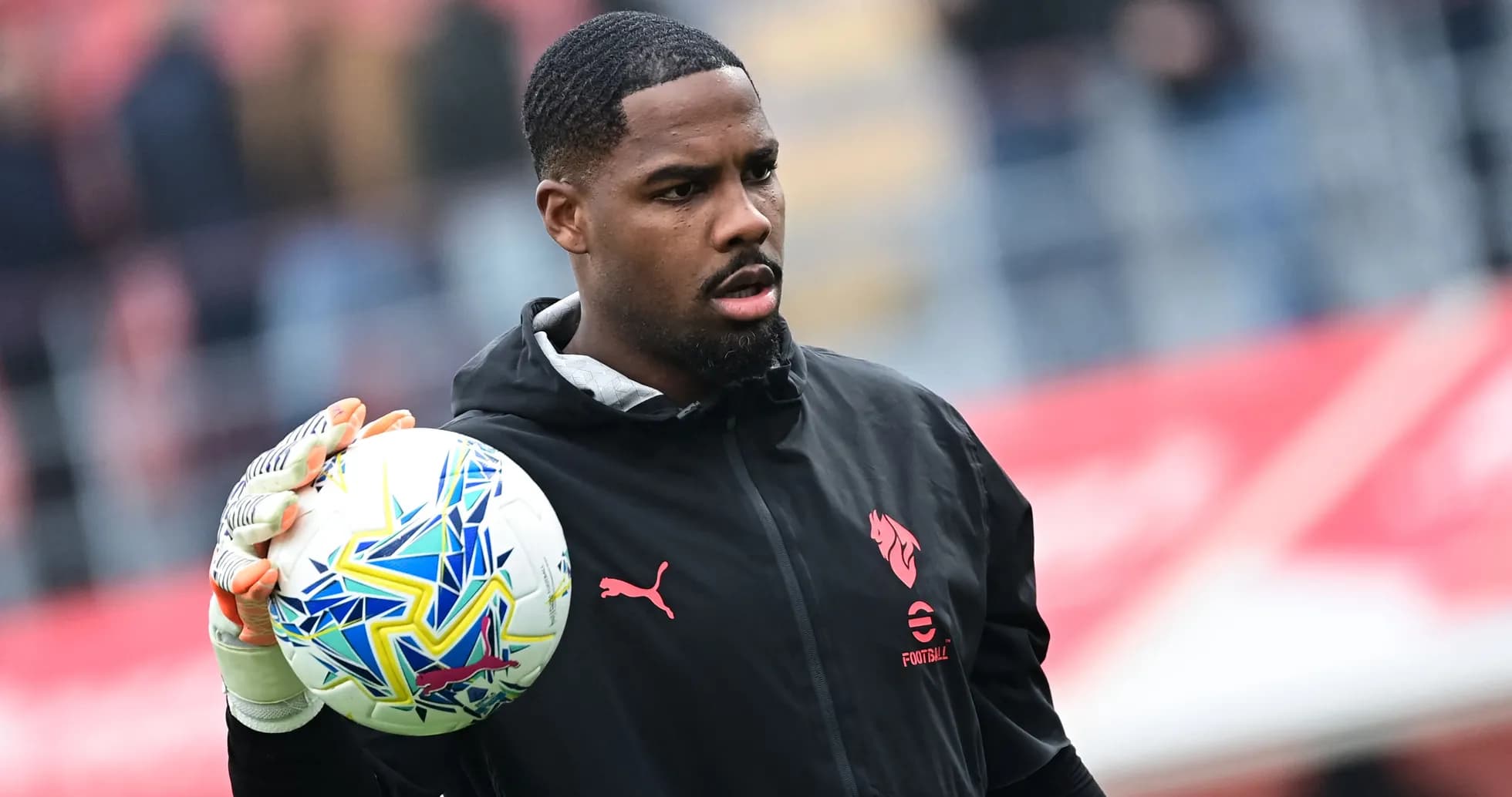 Goalkeeper holding a soccer ball during warm-up Goalkeeper holding a soccer ball during warm-up