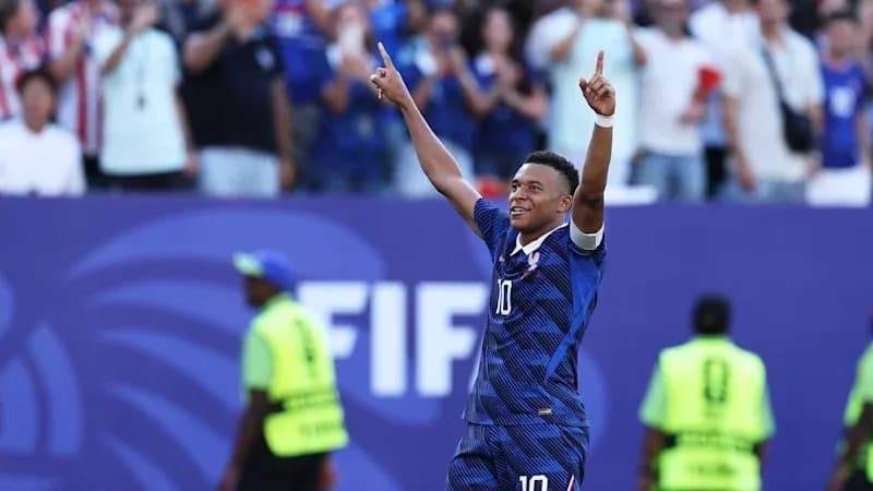 Player celebrating goal with fans in background Player celebrating goal with fans in background