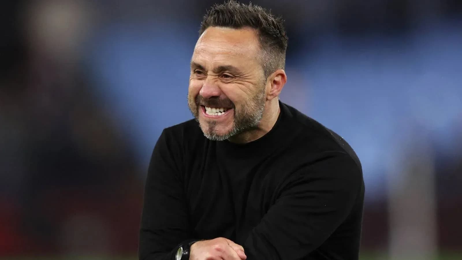 Coach celebrating with a big smile on pitch Coach celebrating with a big smile on pitch
