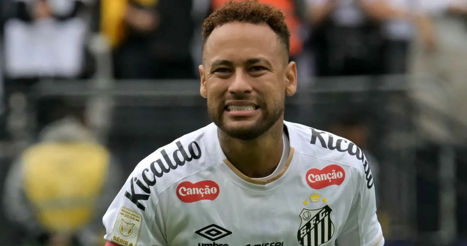 Player celebrating in Santos FC jersey on field Player celebrating in Santos FC jersey on field