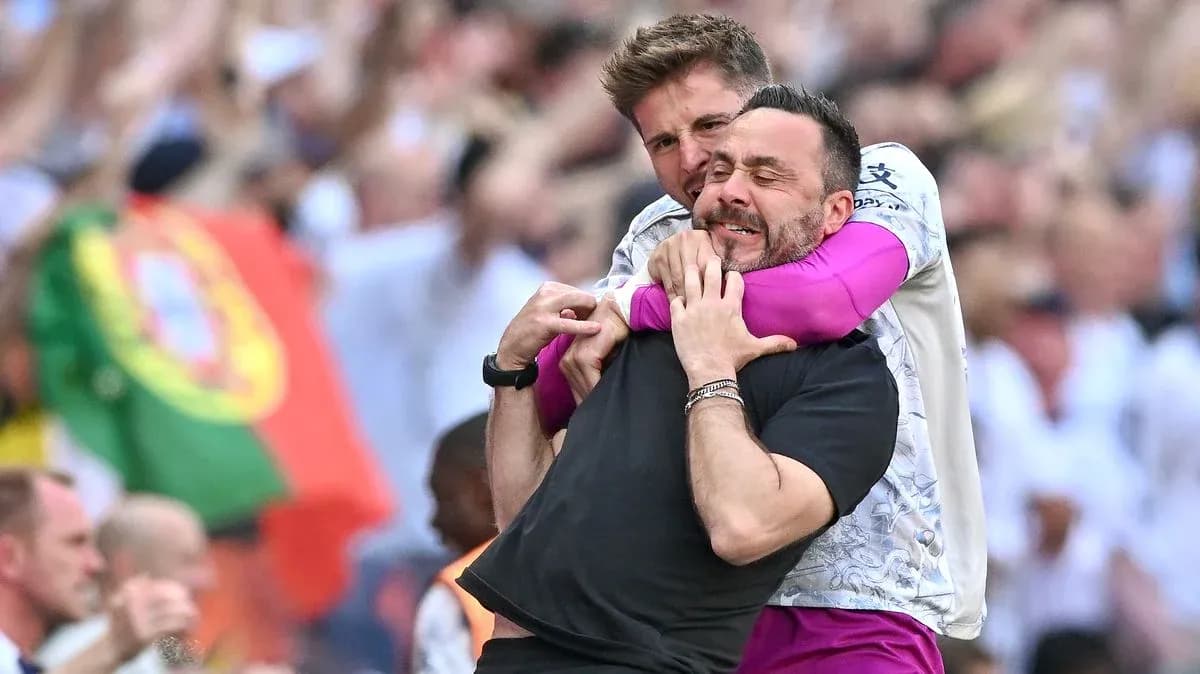 Two coaches celebrating in a crowd during match Two coaches celebrating in a crowd during match
