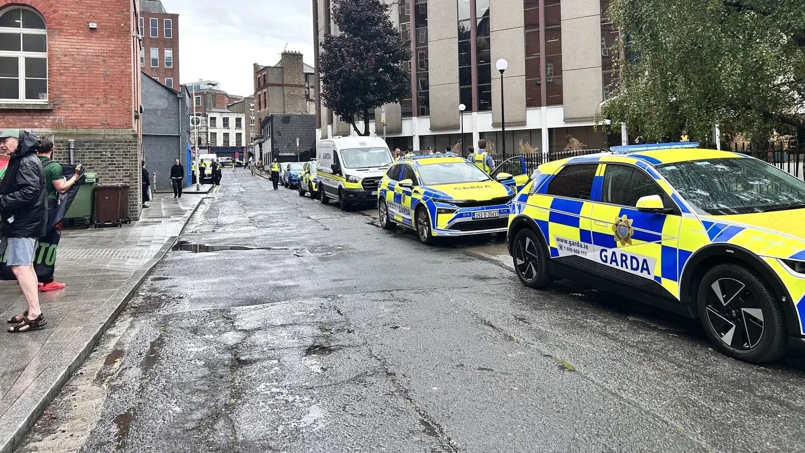 Garda vehicles parked along a wet street Garda vehicles parked along a wet street