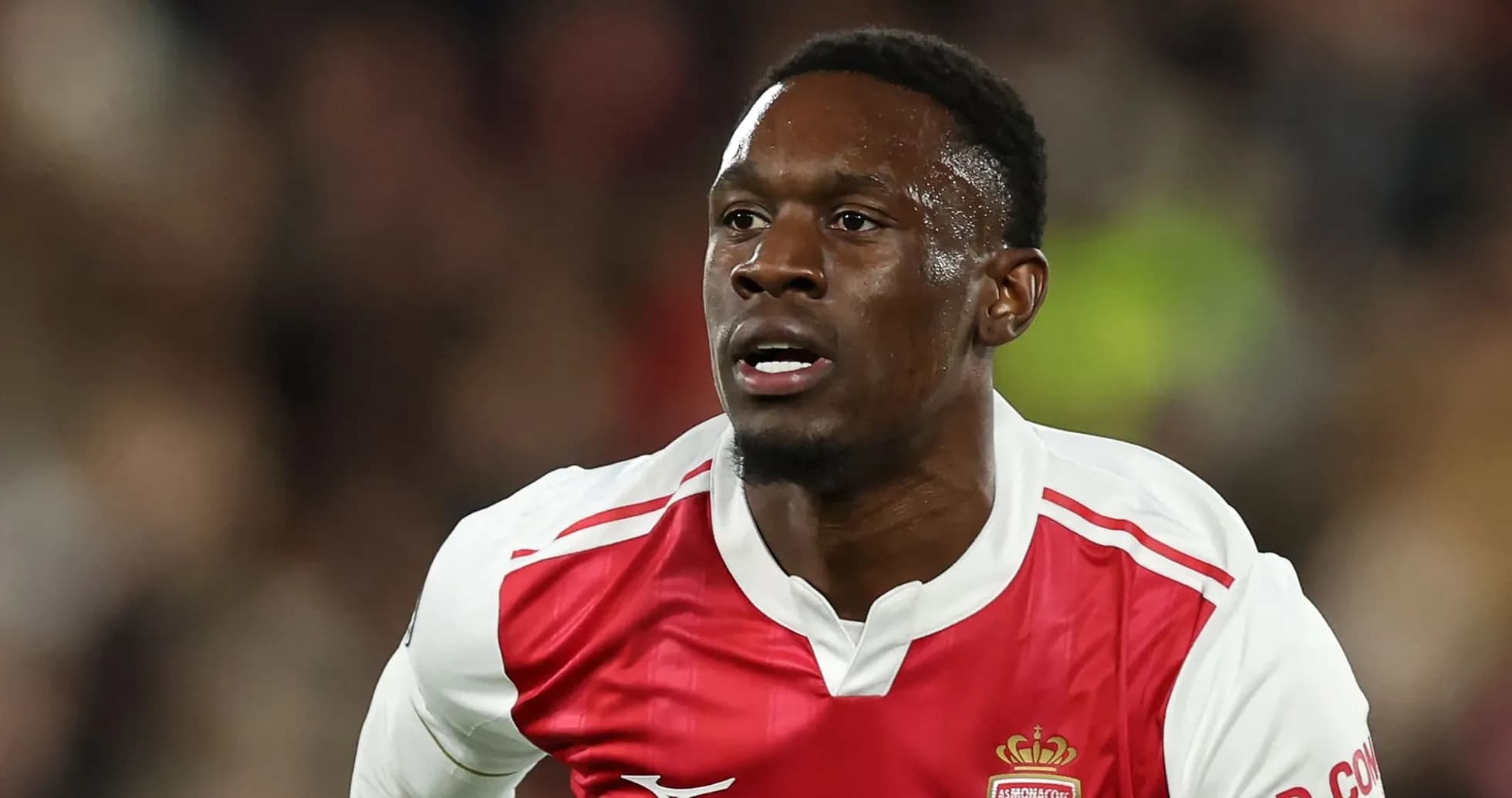 Player in AS Monaco jersey running on the field Player in AS Monaco jersey running on the field