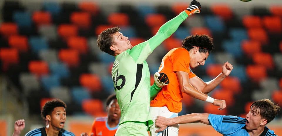 Goalkeeper punching the ball during match Goalkeeper punching the ball during match