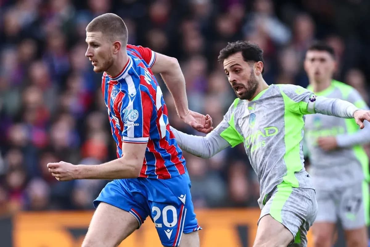 Crystal Palace player challenged by Manchester City opponent Crystal Palace player challenged by Manchester City opponent
