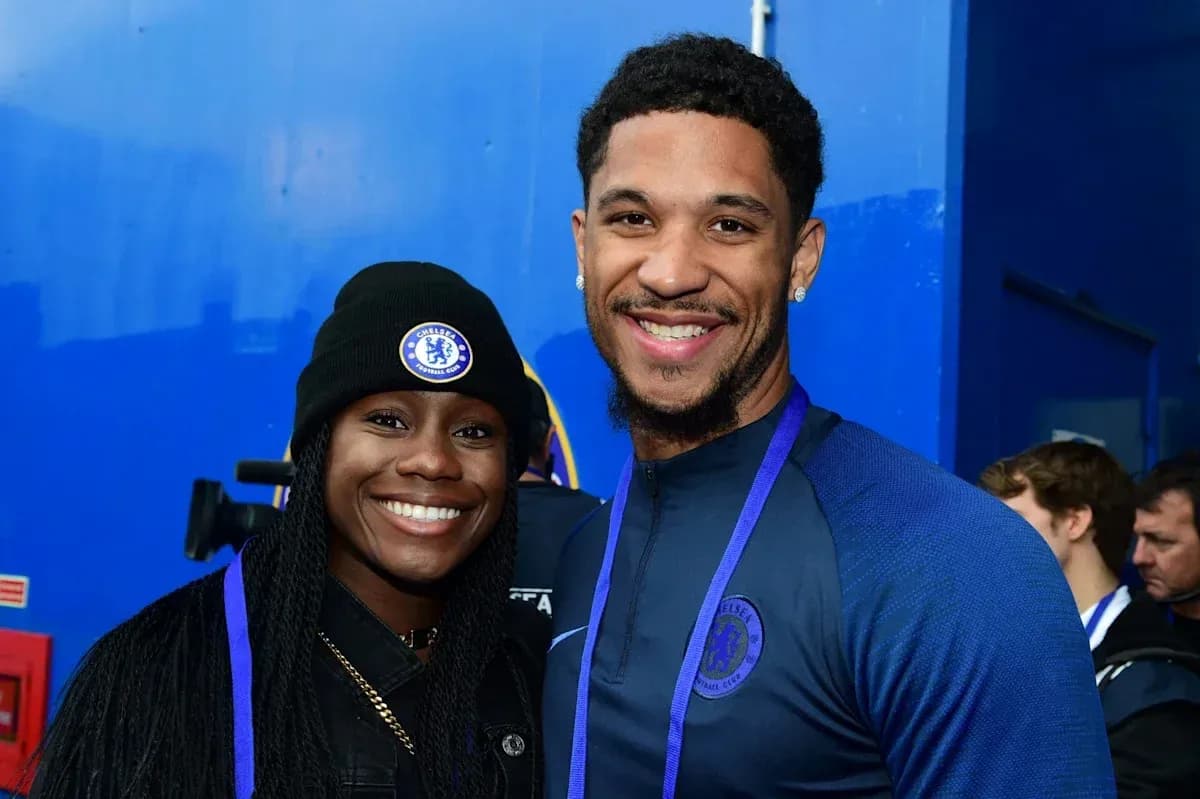Two Chelsea fans posing for a photo together Two Chelsea fans posing for a photo together