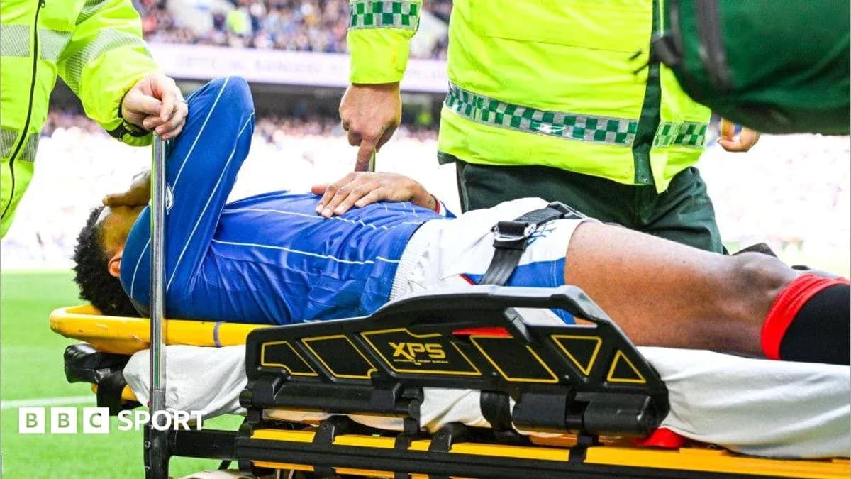 Player being assisted on stretcher by medical staff Player being assisted on stretcher by medical staff