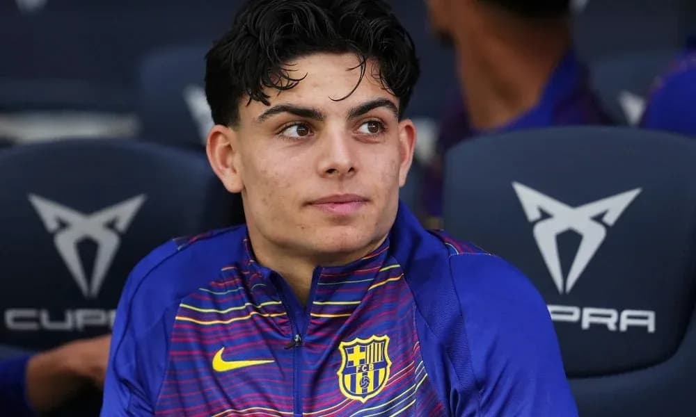 Young player sitting on bench during match Young player sitting on bench during match