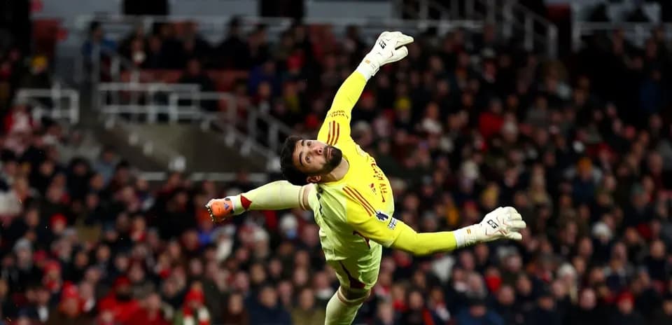 Goalkeeper diving to make a save during match Goalkeeper diving to make a save during match