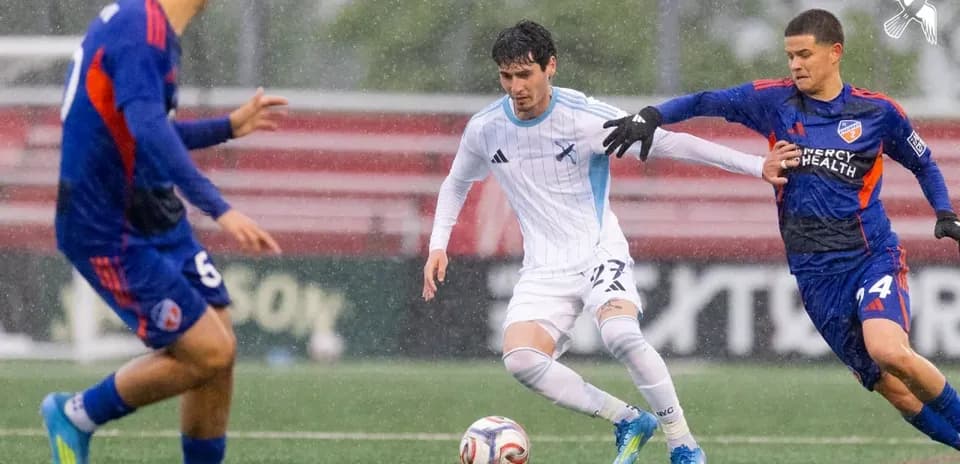 Player dribbling the ball in MLS Next Pro match Player dribbling the ball in MLS Next Pro match