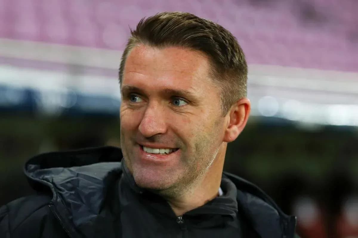 Coach smiling during match warm-up on sidelines Coach smiling during match warm-up on sidelines