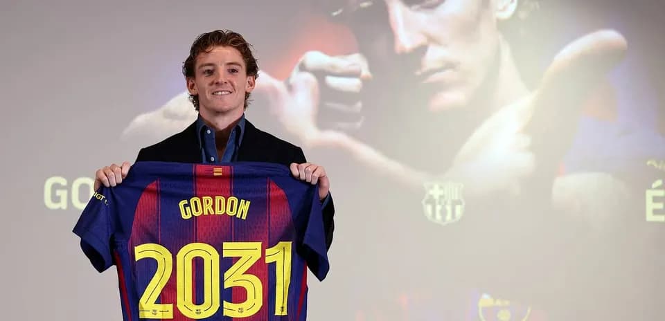 Player holding Barcelona jersey with 'Gordon 2031' Player holding Barcelona jersey with 'Gordon 2031'
