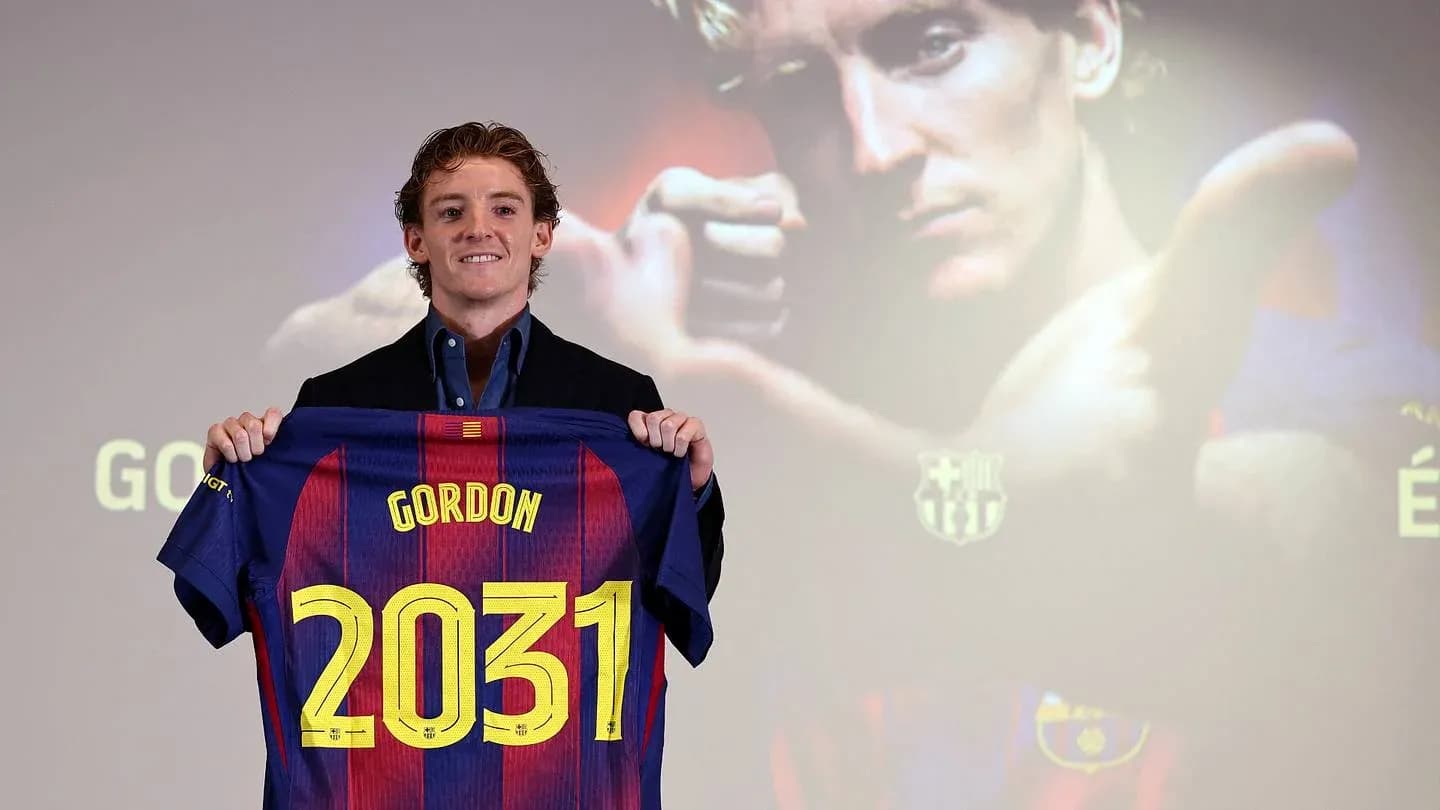 Player holding Barcelona jersey with 'Gordon 2031' Player holding Barcelona jersey with 'Gordon 2031'