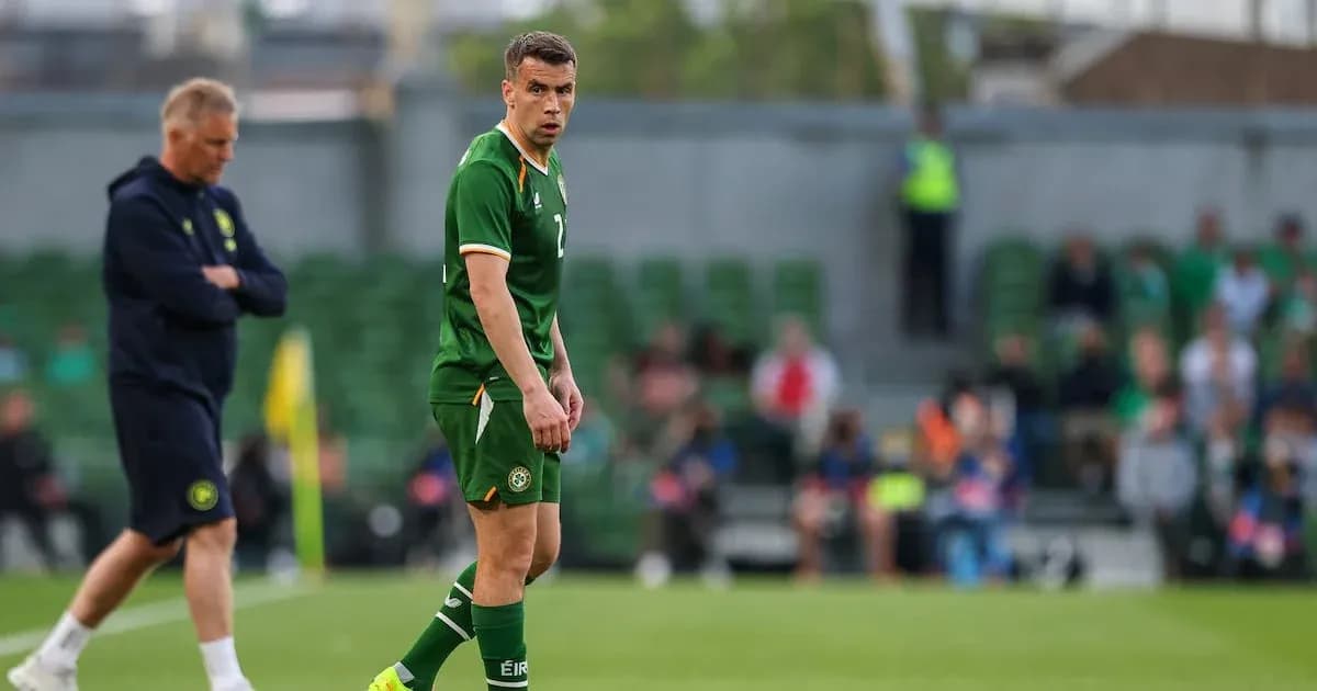 Ireland player on field during match with coach nearby Ireland player on field during match with coach nearby
