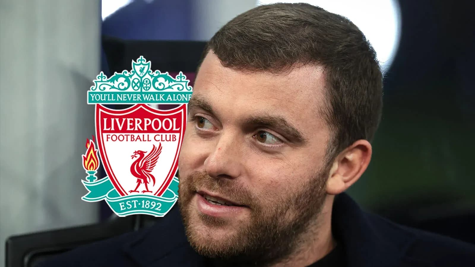 Man with Liverpool FC logo in background Man with Liverpool FC logo in background