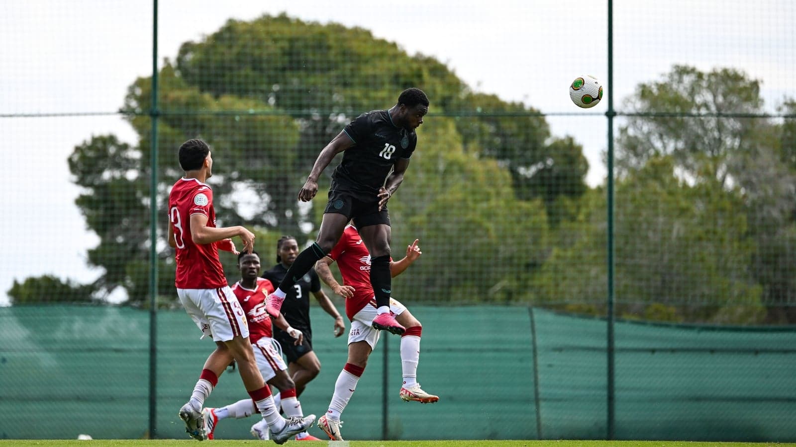 Player jumping to head the ball during training session Player jumping to head the ball during training session