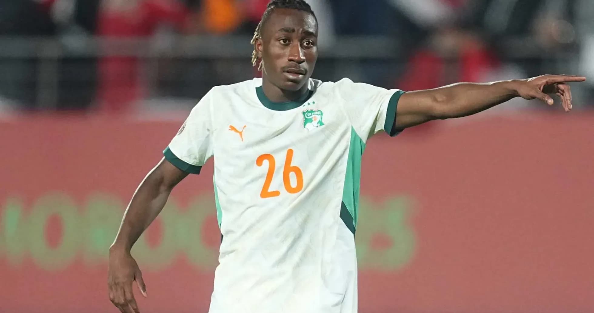 Player in Ivory Coast jersey directing teammates during match Player in Ivory Coast jersey directing teammates during match