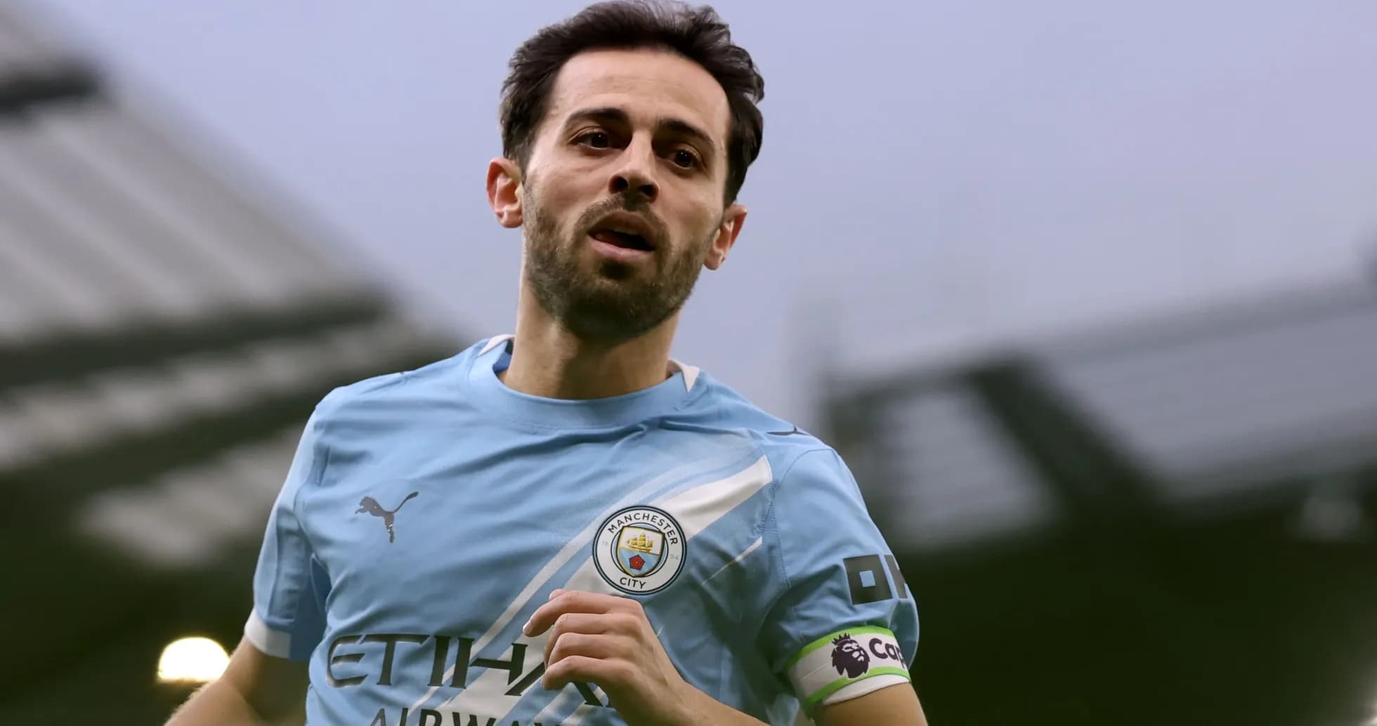 Player running on the pitch wearing Manchester City kit Player running on the pitch wearing Manchester City kit