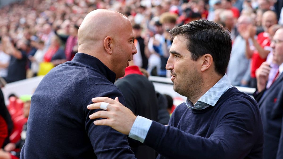 Two coaches greeting each other at a stadium Two coaches greeting each other at a stadium