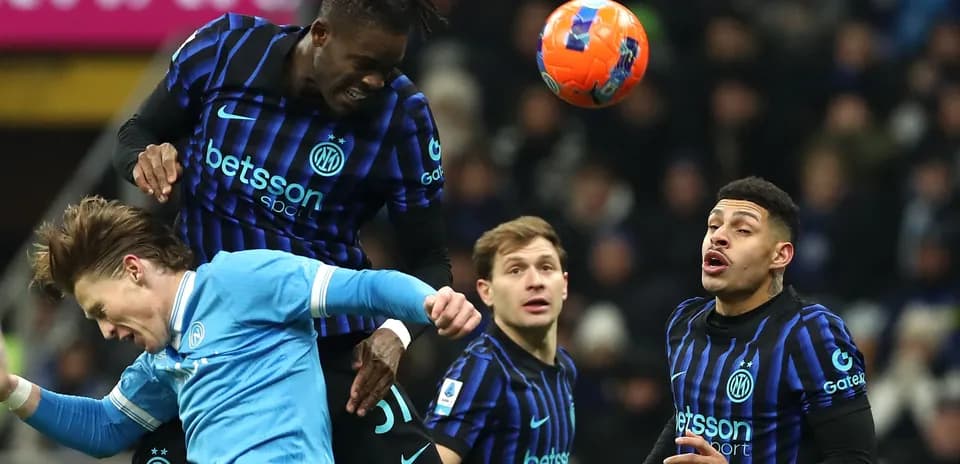 Player heading the ball during a football match Player heading the ball during a football match