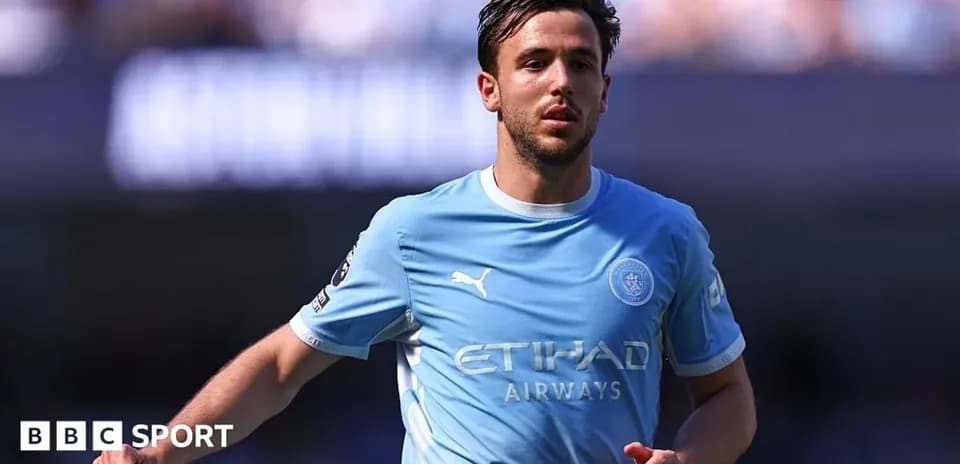 Player in light blue jersey running on the pitch Player in light blue jersey running on the pitch