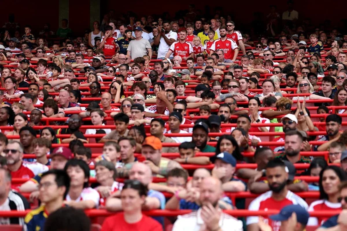 Crowd of fans wearing Arsenal jerseys in stadium Crowd of fans wearing Arsenal jerseys in stadium