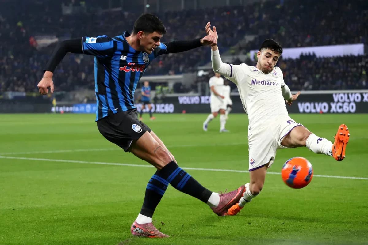 Fiorentina player challenges Atalanta defender for the ball Fiorentina player challenges Atalanta defender for the ball