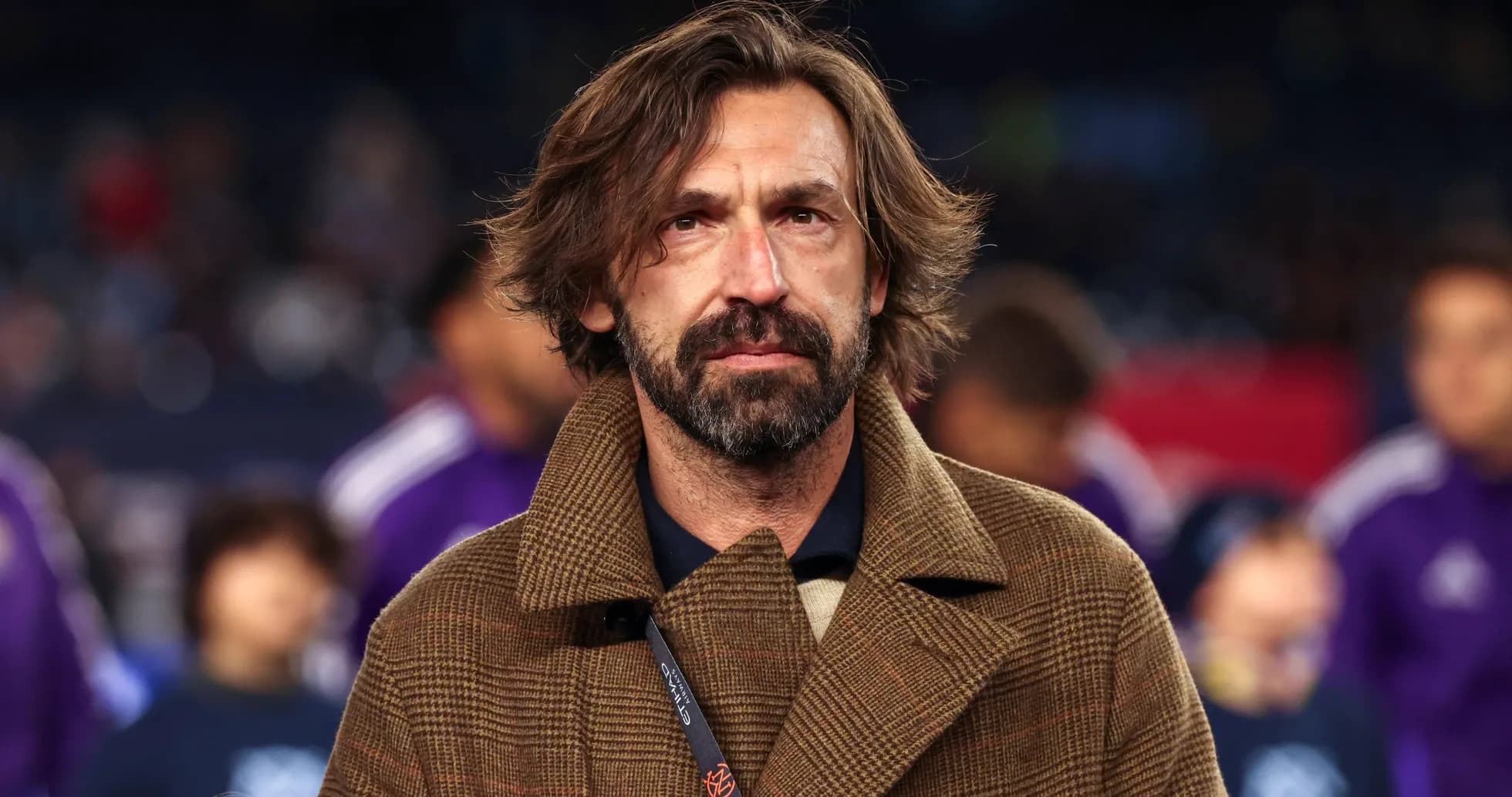 Man in brown coat at a sports event Man in brown coat at a sports event