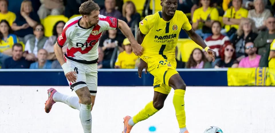 Rayo Vallecano player chasing Villarreal opponent Rayo Vallecano player chasing Villarreal opponent