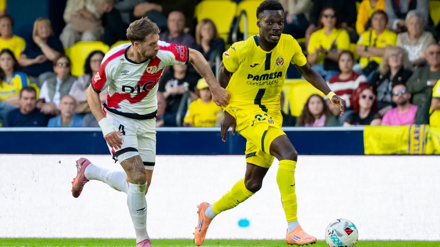 Rayo Vallecano player chasing Villarreal opponent Rayo Vallecano player chasing Villarreal opponent