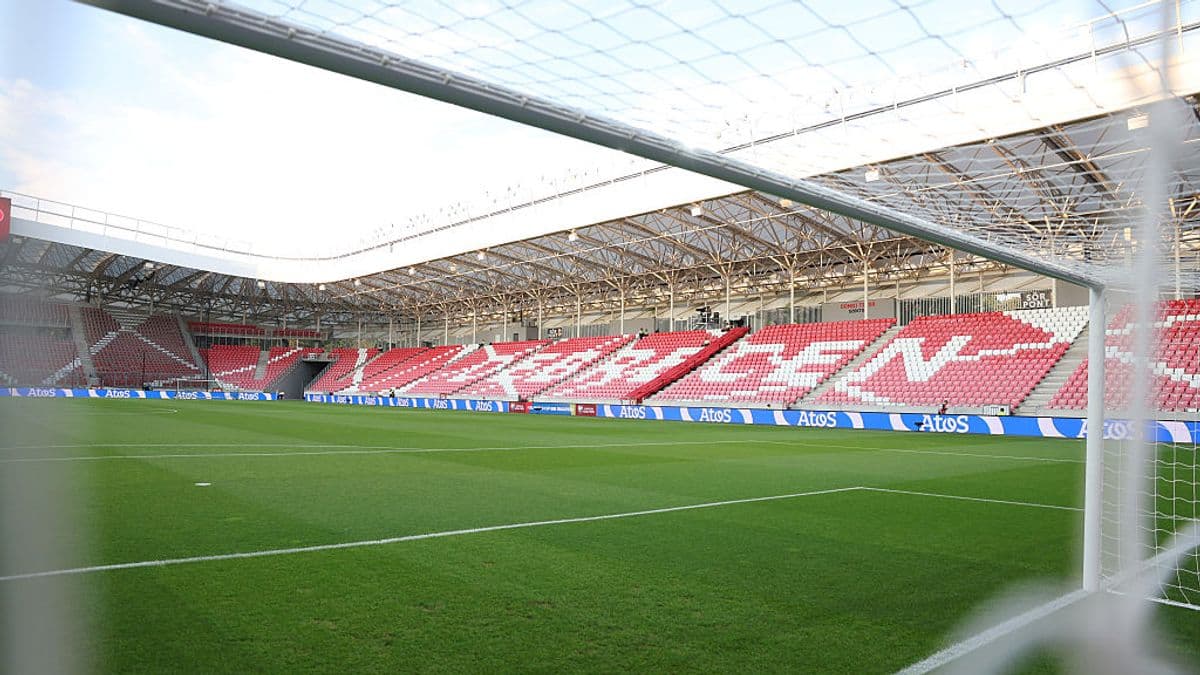 View of stadium interior from behind goal net View of stadium interior from behind goal net