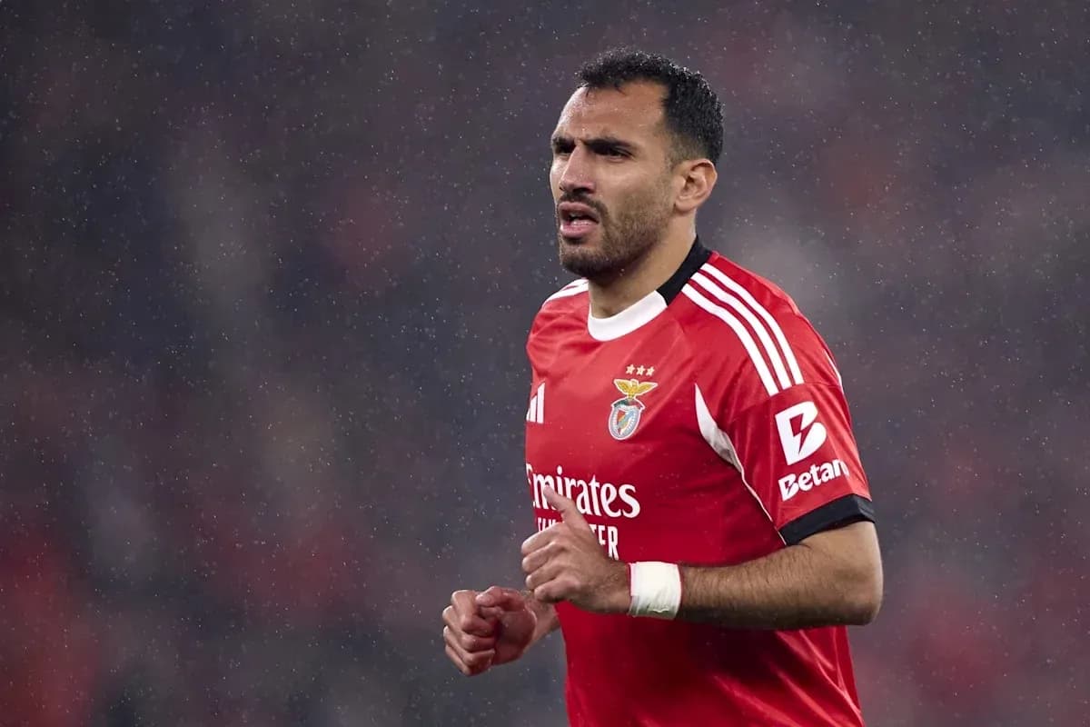 Player in red Benfica kit during rainy match Player in red Benfica kit during rainy match