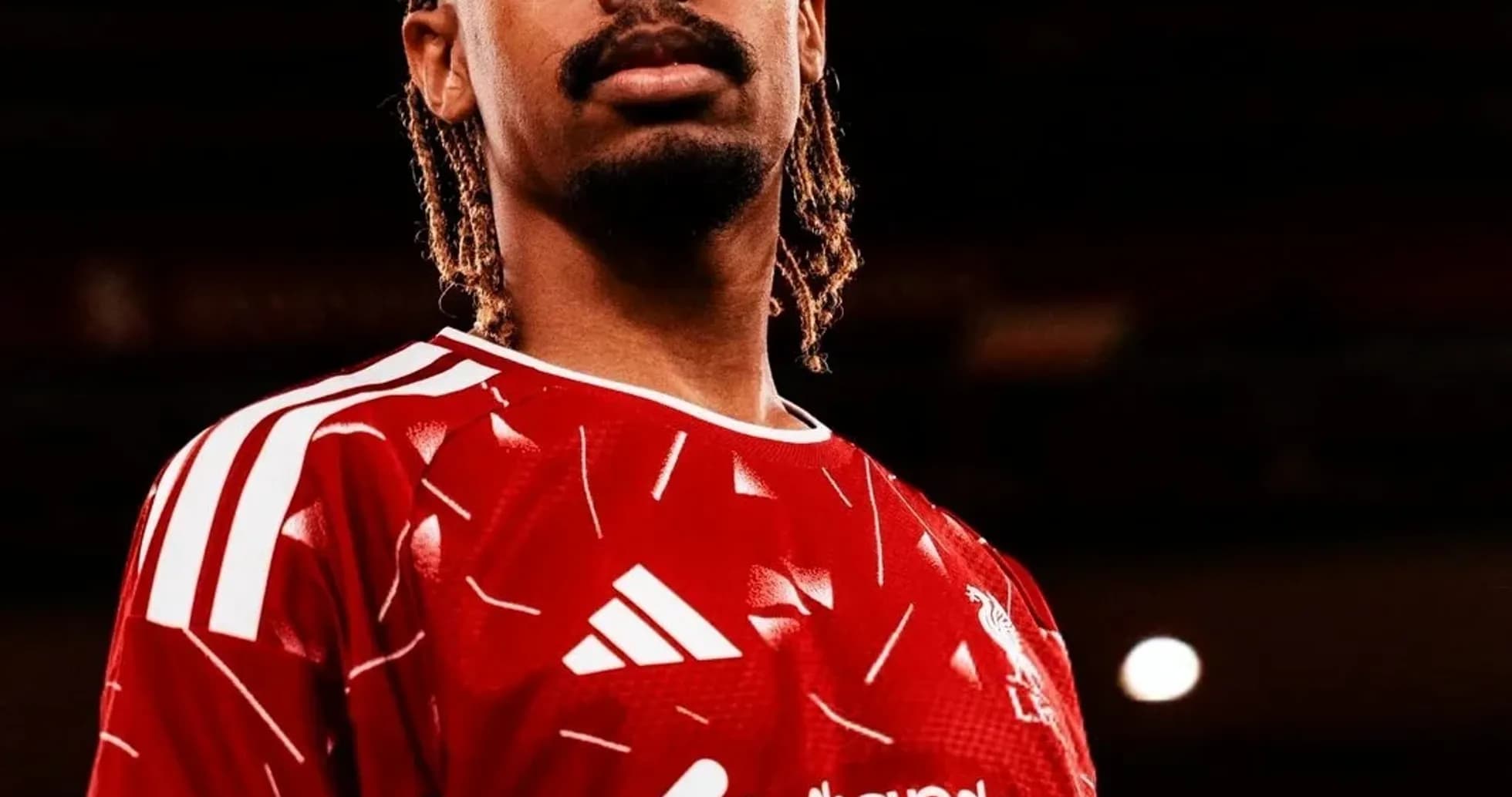 Player posing in red team jersey with logo Player posing in red team jersey with logo