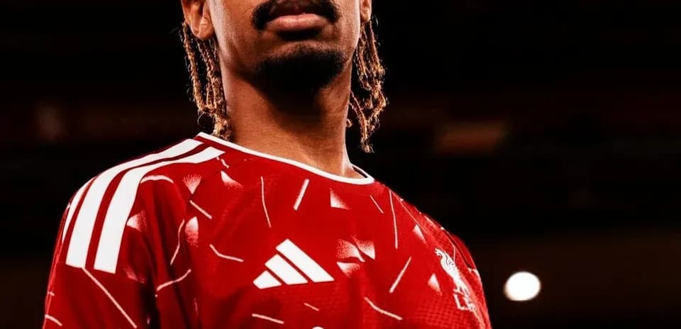 Player posing in red team jersey with logo Player posing in red team jersey with logo