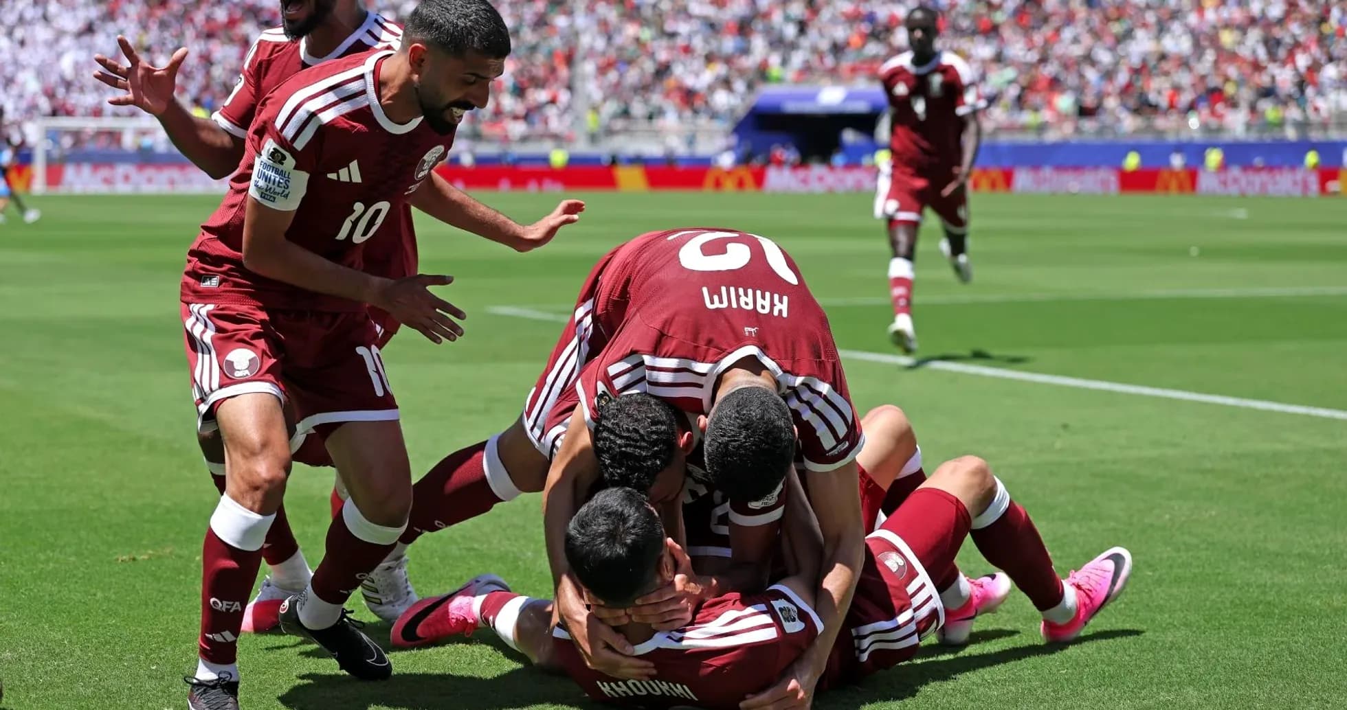 Qatar players celebrating a goal on the field Qatar players celebrating a goal on the field