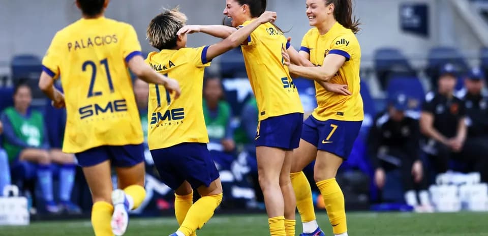 Players celebrating a goal during NWSL match Players celebrating a goal during NWSL match