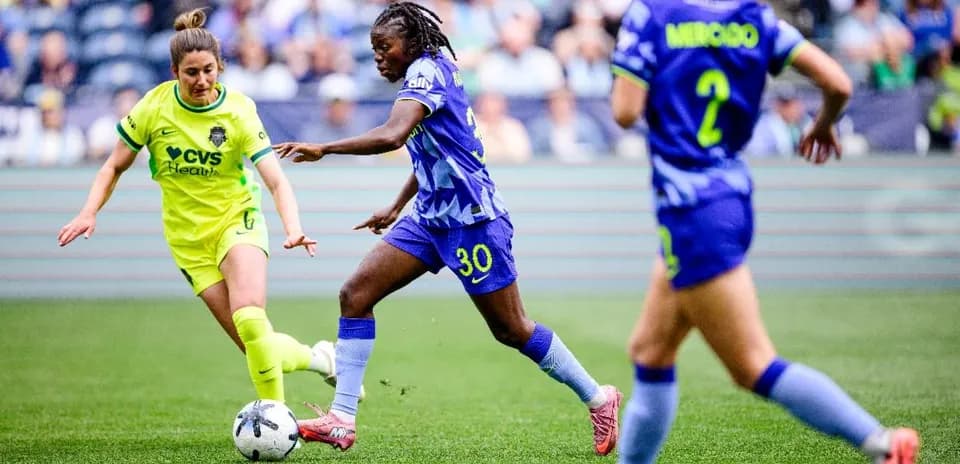 Players competing for the ball in NWSL match Players competing for the ball in NWSL match