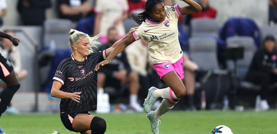 San Diego Wave player tackling Washington Spirit opponent San Diego Wave player tackling Washington Spirit opponent