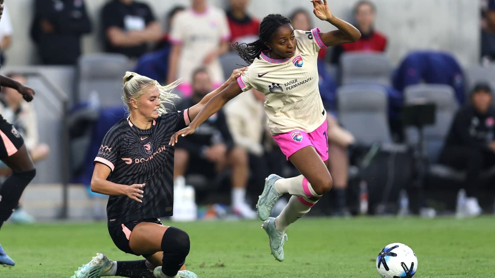 San Diego Wave player tackling Washington Spirit opponent San Diego Wave player tackling Washington Spirit opponent