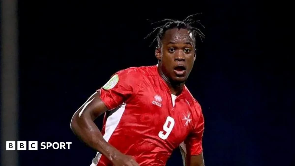 Player in red jersey during a football match Player in red jersey during a football match