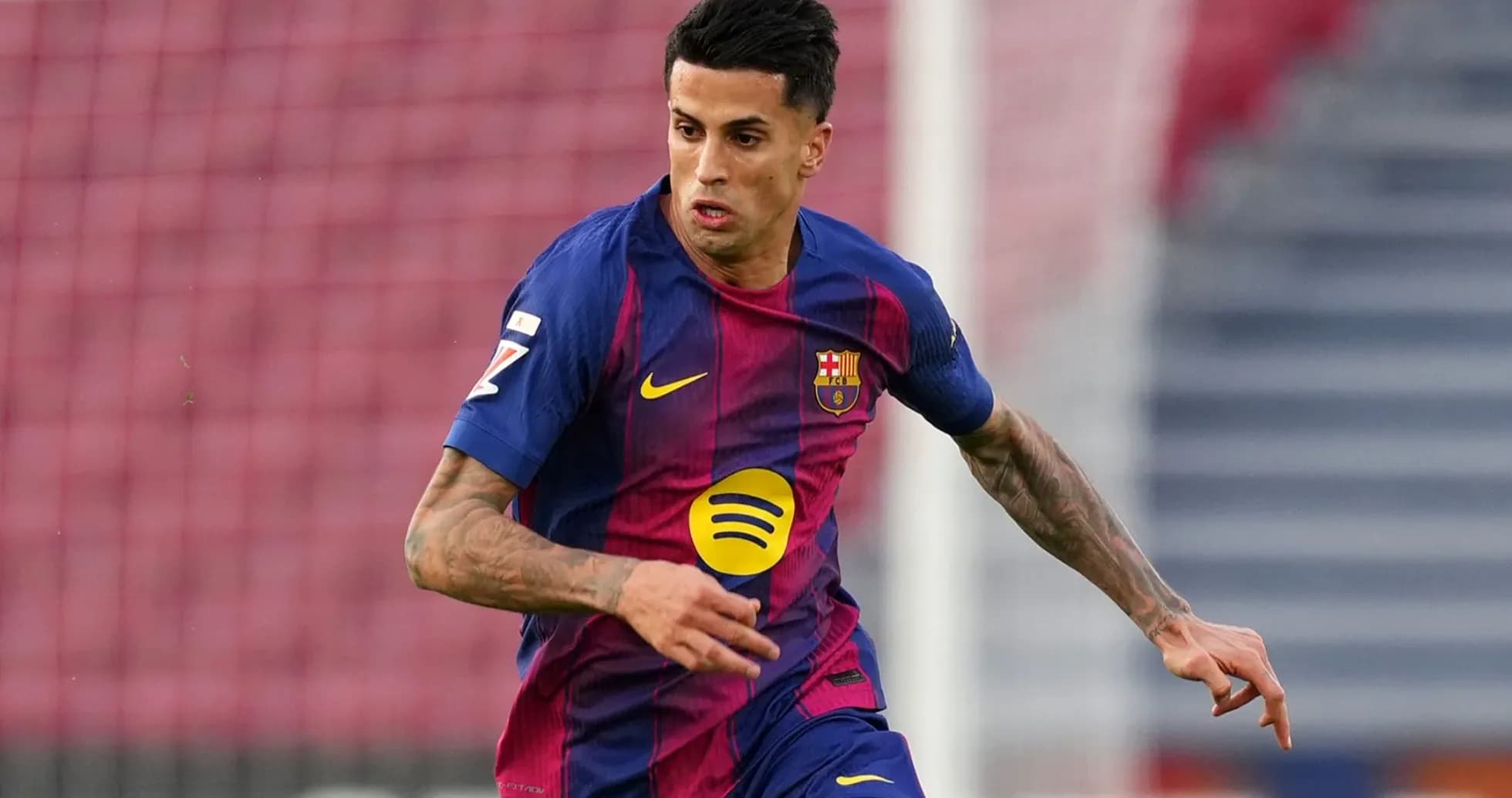 Player in Barcelona kit running on the field Player in Barcelona kit running on the field