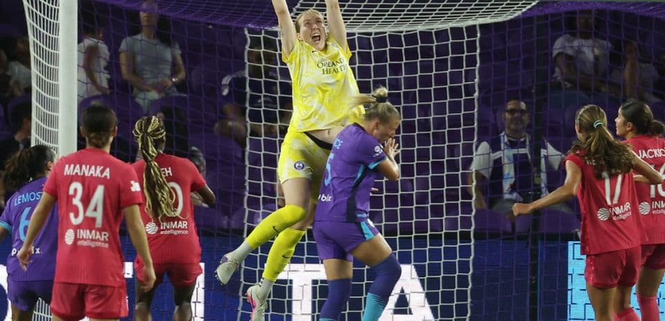 Goalkeeper leaps to catch the ball during match Goalkeeper leaps to catch the ball during match