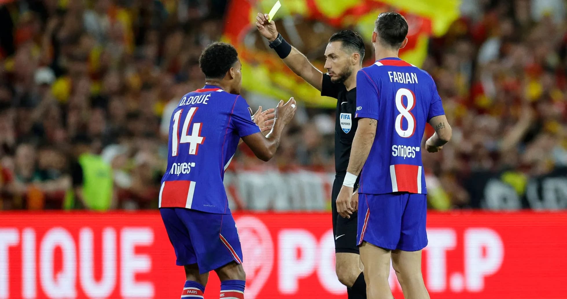 Referee showing yellow card to player during match Referee showing yellow card to player during match