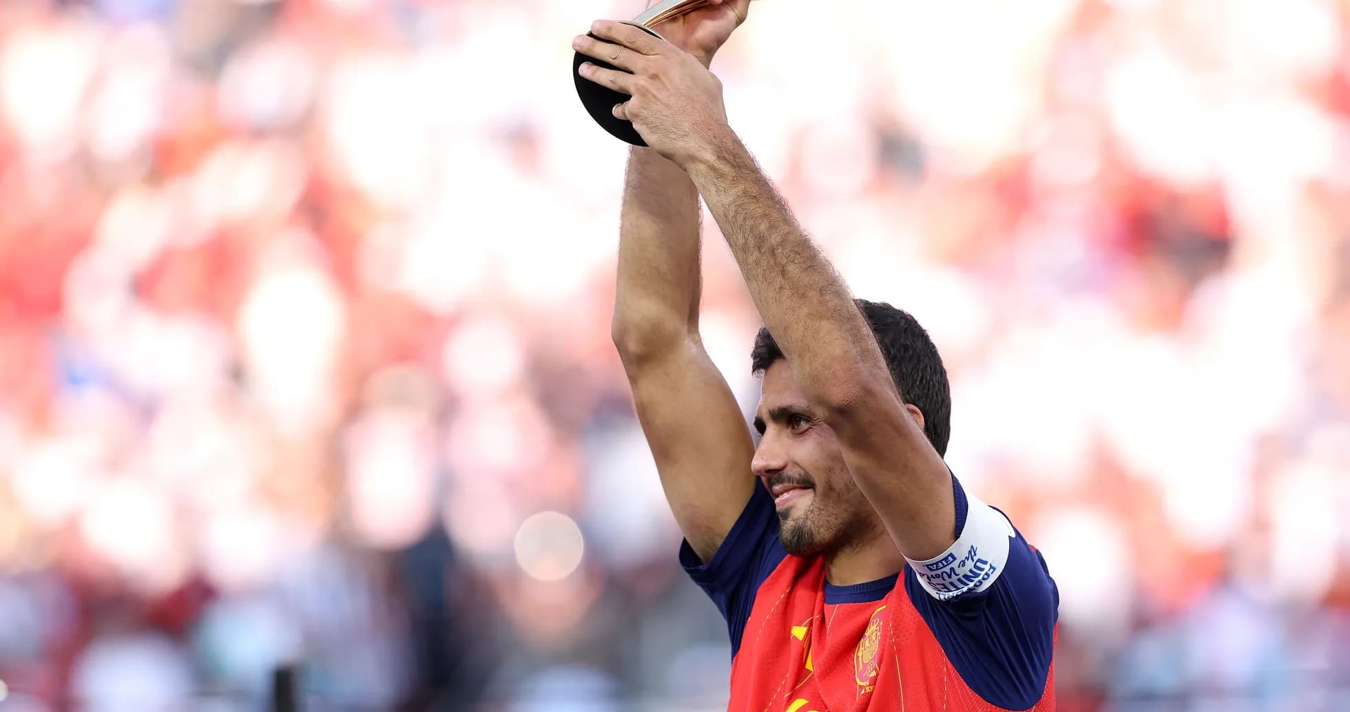 Player holding trophy aloft in celebration Player holding trophy aloft in celebration